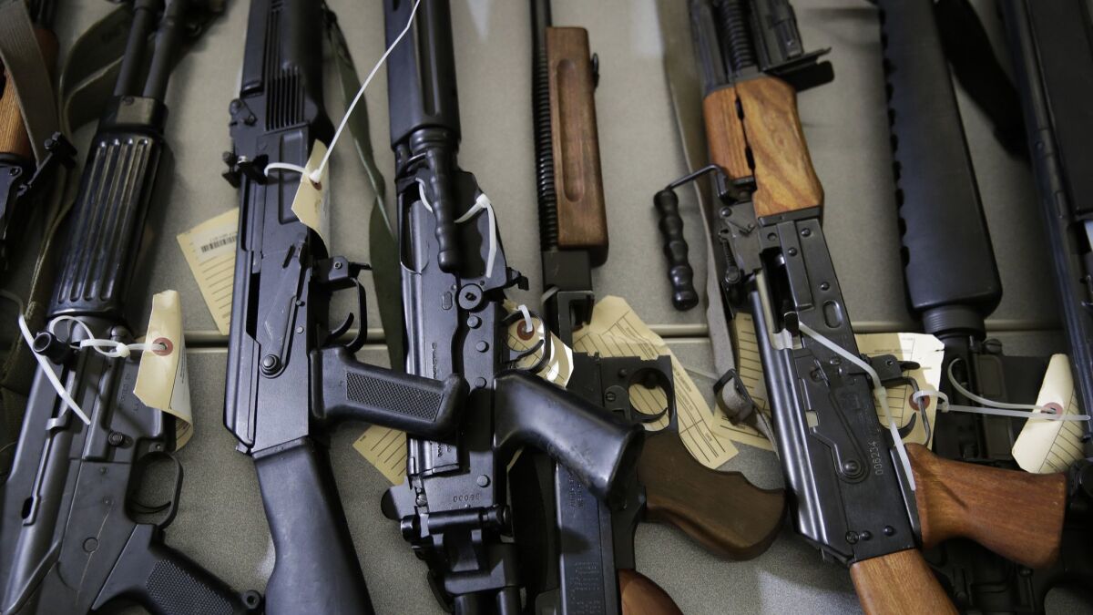 Illegally possessed firearms seized by authorities are displayed in Los Angeles.
