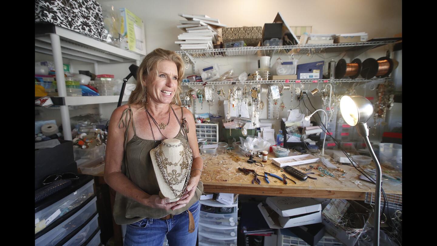 Jewelry artist Gina Hueston in her home workshop in Newport Beach.
