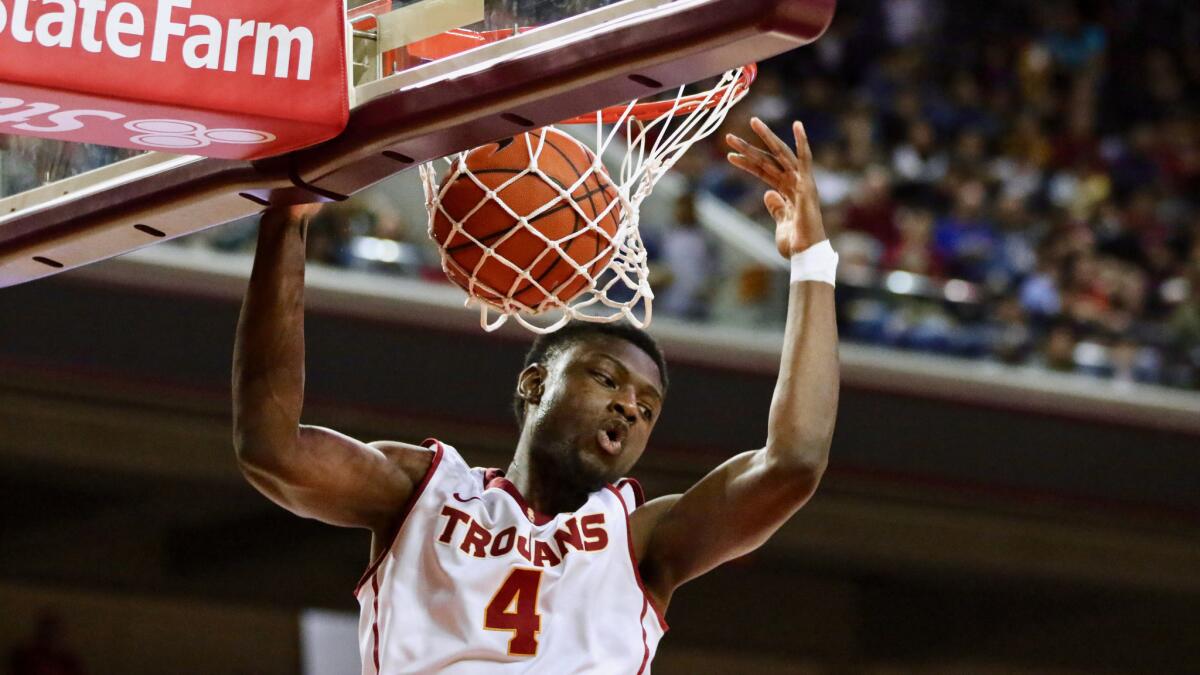 USC forward Chimezie Metu dunks a basket in the first half against Washington on March 4.