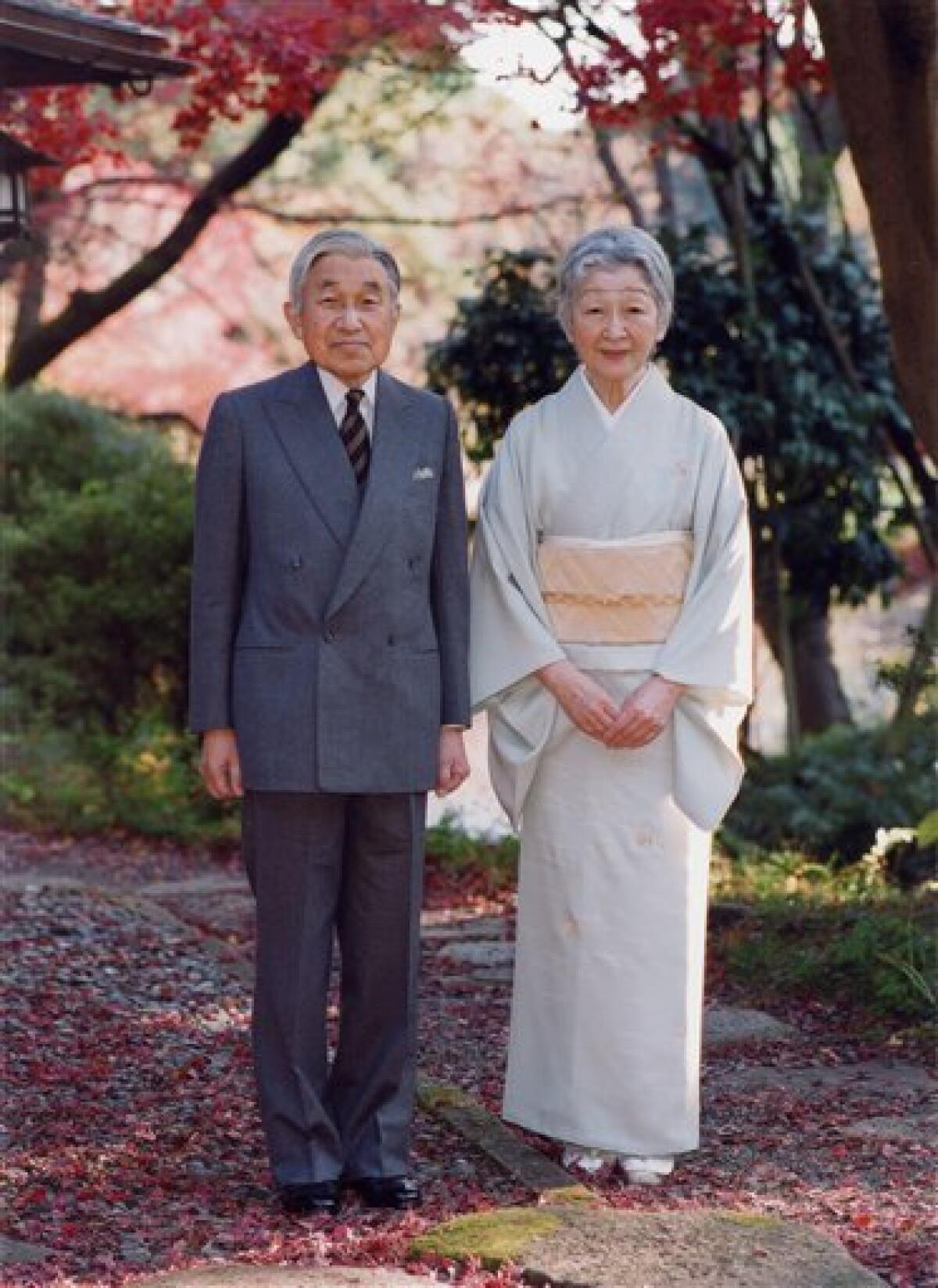 In this photo taken on Monday, Nov. 29, 2010 and released by the Imperial Household Agency of Japan, Emperor Akihito and Empress Michiko stand together by Sokintei arbor during their stroll at Fukiage Garden in the Imperial Palace in Tokyo. Akihito celebrates his 77th birthday Thursday, Dec. 23, 2010. (AP Photo/Imperial Household Agency of Japan) EDITORIAL USE ONLY
