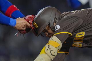 San Diego Padres' José Azocar gets caught between first and second bases and is tagged out at first by Chicago Cubs catcher Miguel Amaya during the seventh inning of a baseball game Tuesday, May 7, 2024, in Chicago. (AP Photo/Erin Hooley)