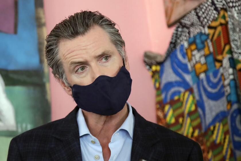 FILE - In this June 9, 2020, file photo, California Gov. Gavin Newsom wears a protective mask on his face while speaking to reporters at Miss Ollie's restaurant during the coronavirus outbreak in Oakland, Calif. Following a weekend that allowed California's broadest reopening yet, Newsom on Monday, June 15, 2020, defended the state's pace of easing coronavirus restrictions and said the economic harm they inflicted have negative health outcomes, too. "We have to recognize you can't be in a permanent state where people are locked away for months and months and months and months on end," he said, adding the state must consider the health impacts of seeing "lives and livelihoods completely destroyed. (AP Photo/Jeff Chiu, Pool, File)