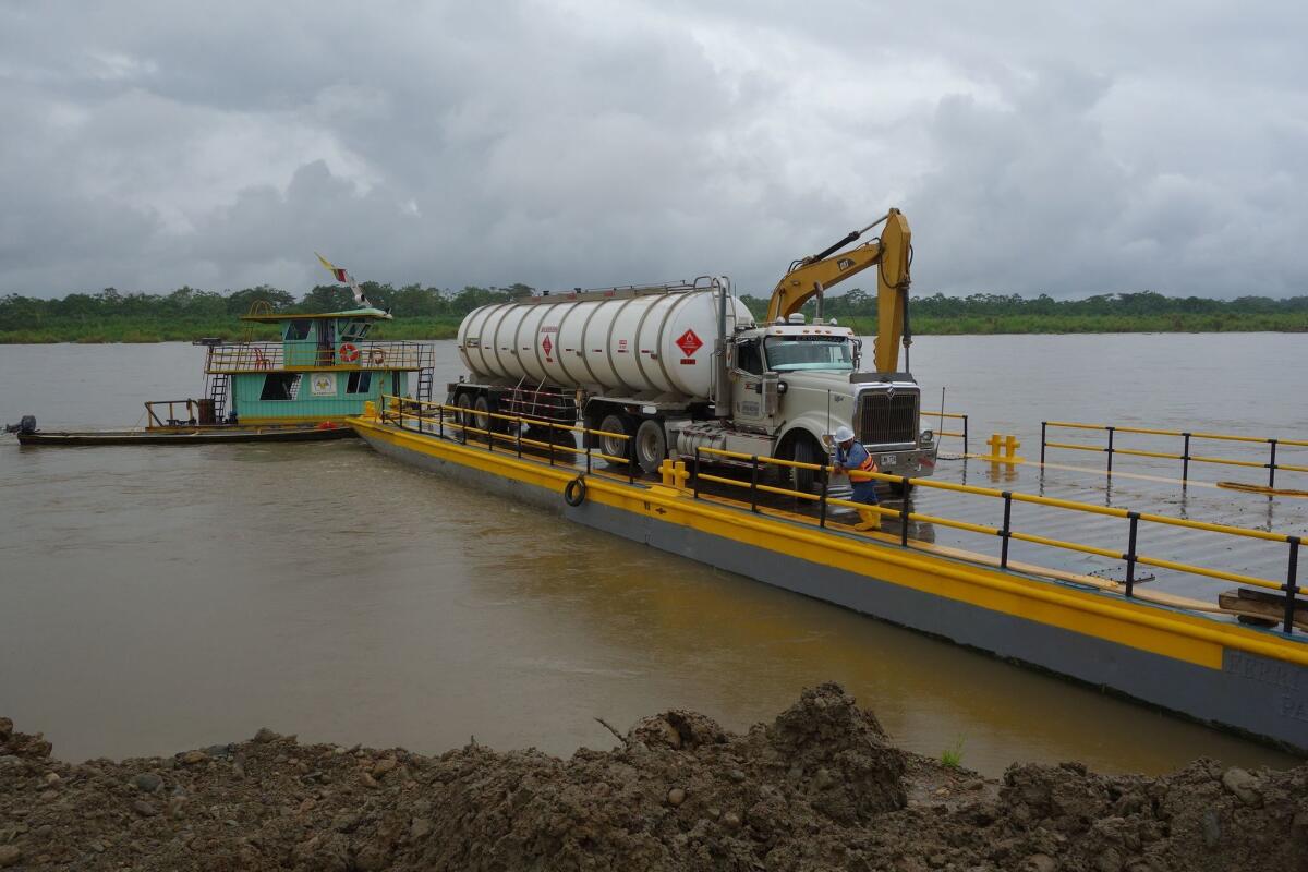 A tanker truck is shown being ferried across the Putumayo River in southern Colombia on Saturday. FARC guerrillas last week forced drivers of 22 of the vehicles to dump their loads on highways around Puerto Asis.