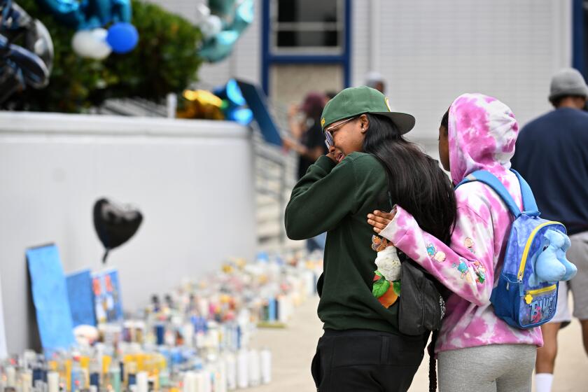 Los Angeles, California June 12, 2023-Students console each other outside Crenshaw High School after basketball player Quincy Reese Jr. was shot and killed at a party Saturday. (Wally Skalij/Los Angles Times)