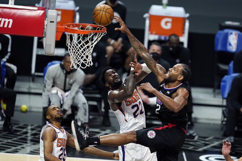 Clippers forward Kawhi Leonard dunks over Phoenix Suns center Deandre Ayton.
