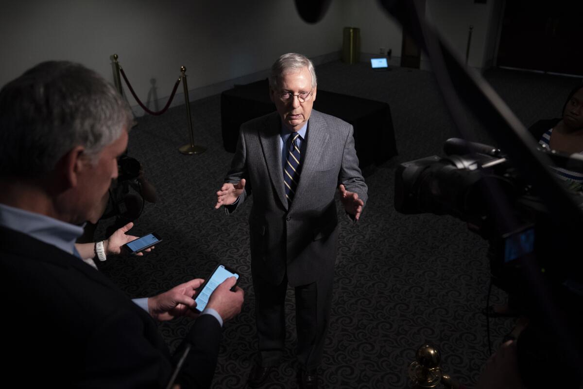 Senate Majority Leader Mitch McConnell speaks to reporters after a meeting on an economic rescue package to deal with the effects of the coronavirus.