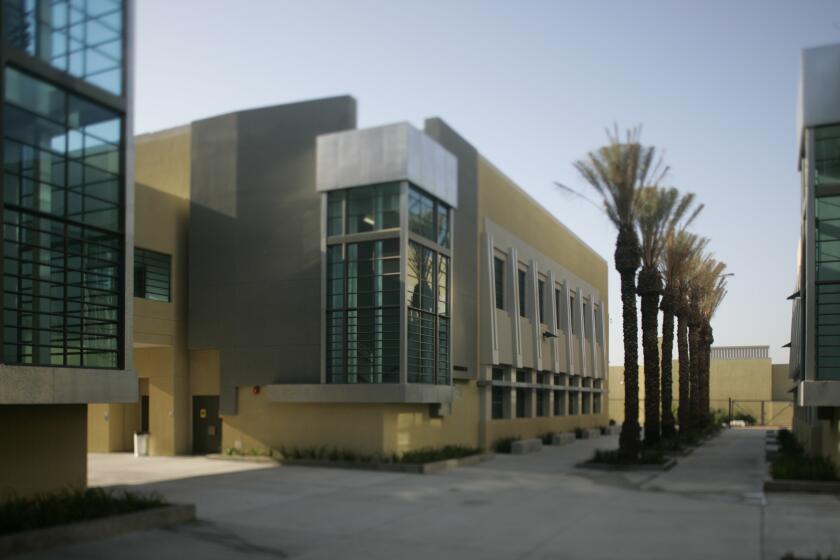 Seib, Al –– – 102461.CA.0920.schools.ALS––South East High School is one of six LAUSD schools that is being reviewed architecturally for the Sunday Calendar. North Hollywood's focus wll be it's Facade of auditorium building, abstracted Mayan detailing, "Palm court" walkway lined with palm trees, and parking lot that separates front of school from Tweedy Blvd.