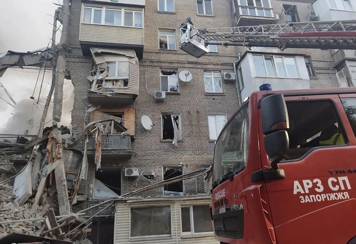 Rescuers work at the scene of building damaged by shelling in Zaporizhzhia, Ukraine.