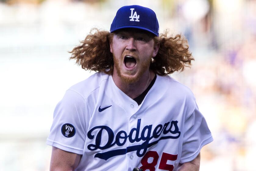 Los Angeles Dodgers starting pitcher Dustin May reacts on the mound after striking out.