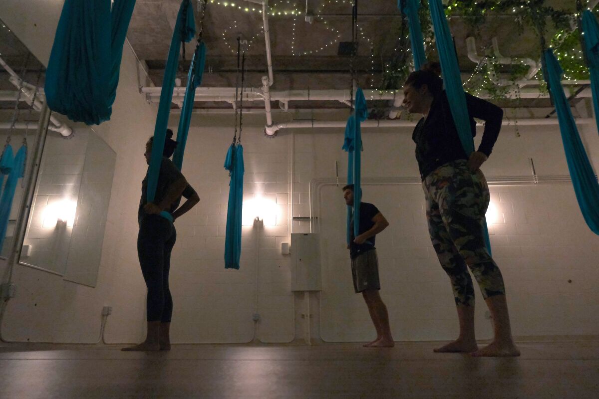 Jasmine and Correy take part in an aerial yoga lesson during their date at Rize Studio in the East Village.