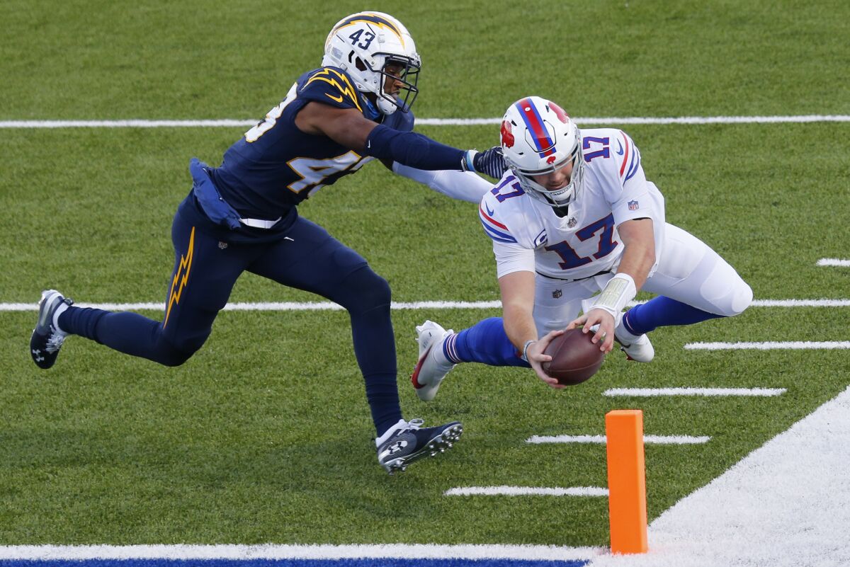 Buffalo Bills quarterback Josh Allen scores a touchdown ahead of Chargers cornerback Michael Davis.