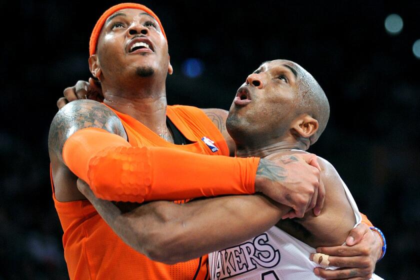Carmelo Anthony and Kobe Bryant battle for rebounding position during a Knicks-Lakers game on Christmas Day in 2014.