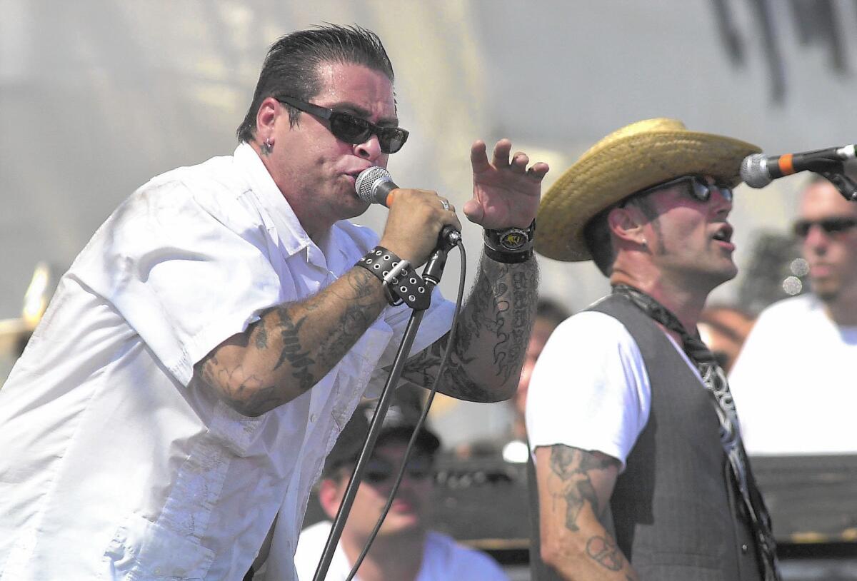 The Cadillac Tramps' Mike "Gabby" Gaborno, left, and guitarist Brian Coakley play the 2001 Hootenanny Festival in Irvine.