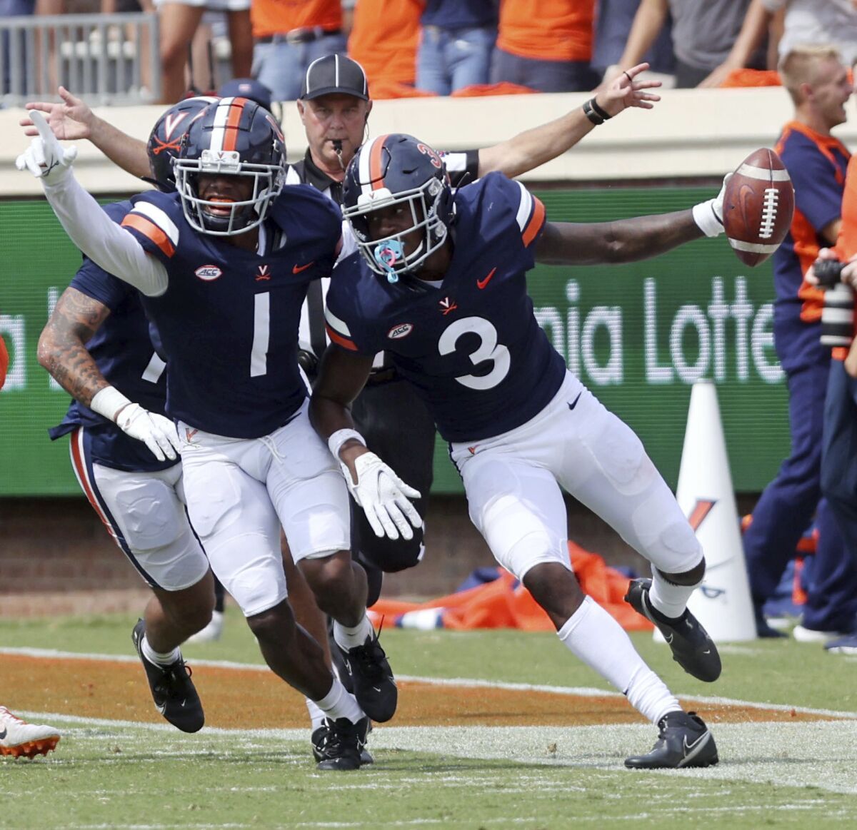 Virginia's Nick Grant (1) celebrates an interception by teammate Anthony Johnson (3) during an NCAA college football game against Illinois, Saturday, Sept. 11, 2021, at Scott Stadium in Charlottesville, Va. (Andrew Shurtleff/The Daily Progress via AP)