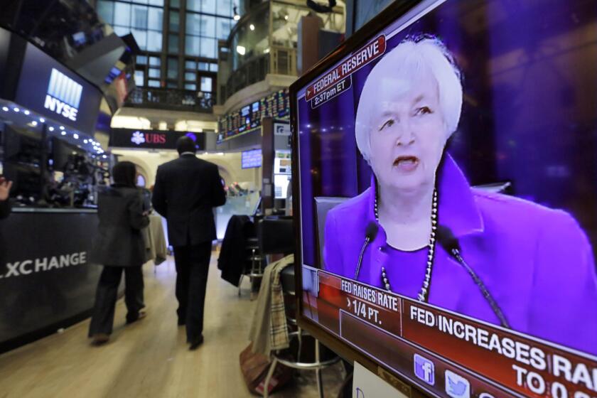 Federal Reserve Chairwoman Janet L. Yellen's Washington news conference is shown on a television screen on the floor of the New York Stock Exchange in December.