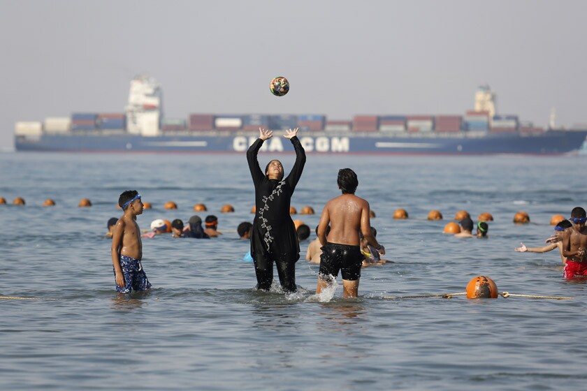 A woman in a burkini joins others at a beach in Suez, Egypt, in 2018.