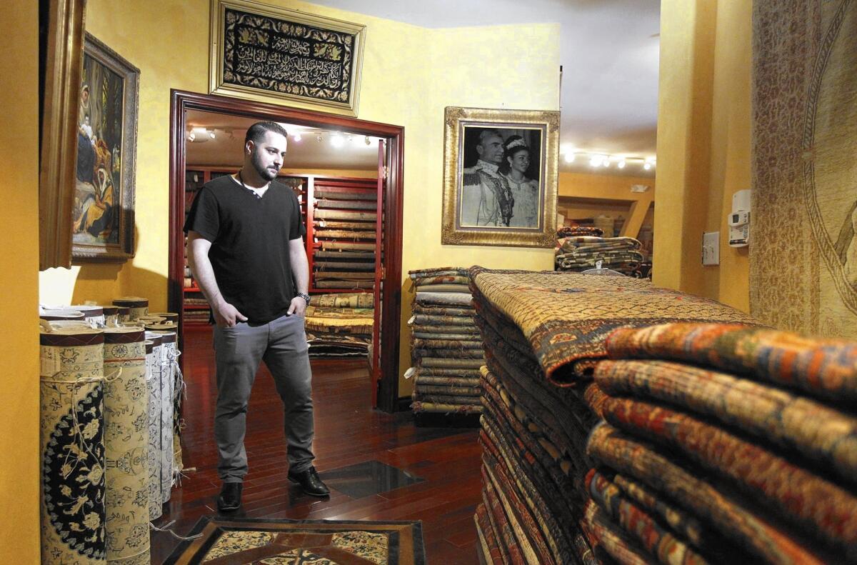 Adel Tousi in his Persian rug company's huge showroom. At the height of their business, Tousi’s father would import hundreds — sometimes thousands — of rugs at a time, filling large shipping containers to the brim.
