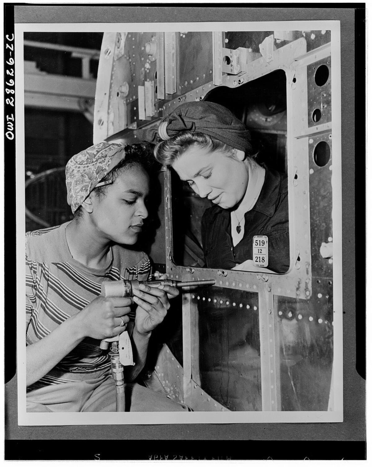 Dora Miles and Dorothy Johnson at the Long Beach plant of Douglas Aircraft Co. Douglas' factories were considered an industrial melting pot as men and women of 58 national origins worked side by side during the war.