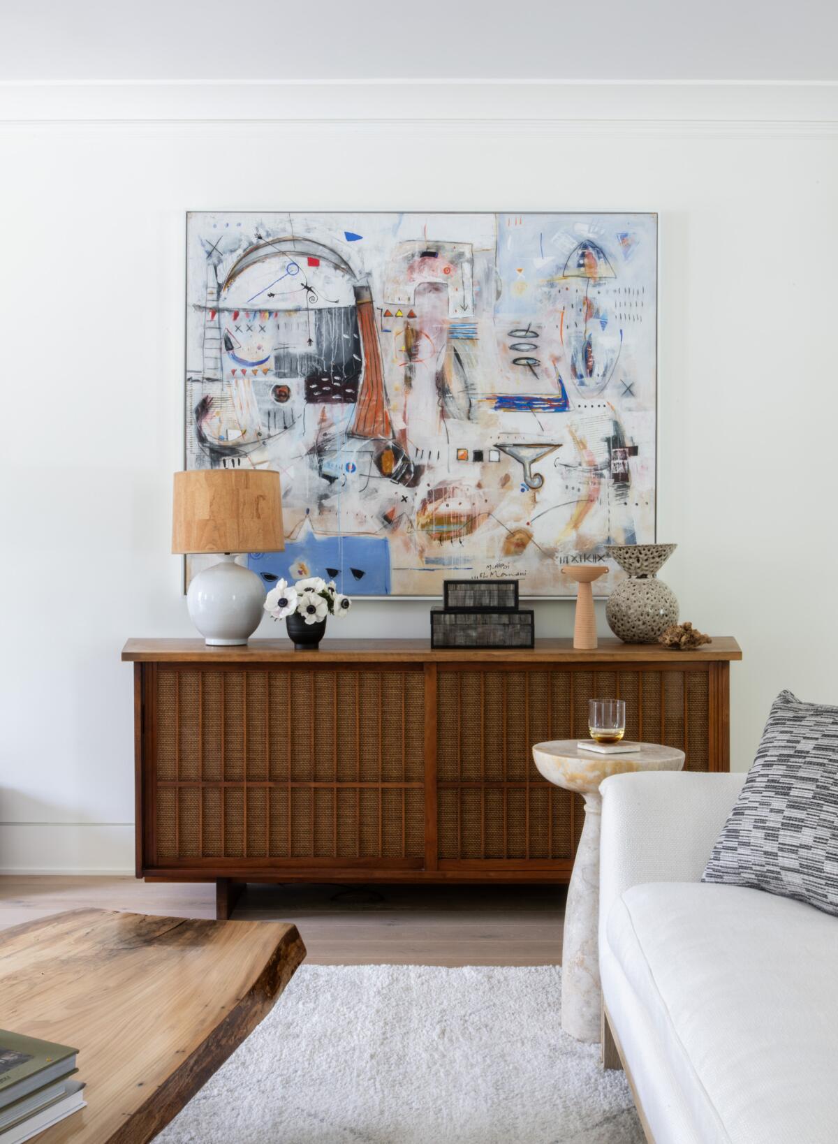 An abstract painting inspires the palette and furnishings of this living room.
