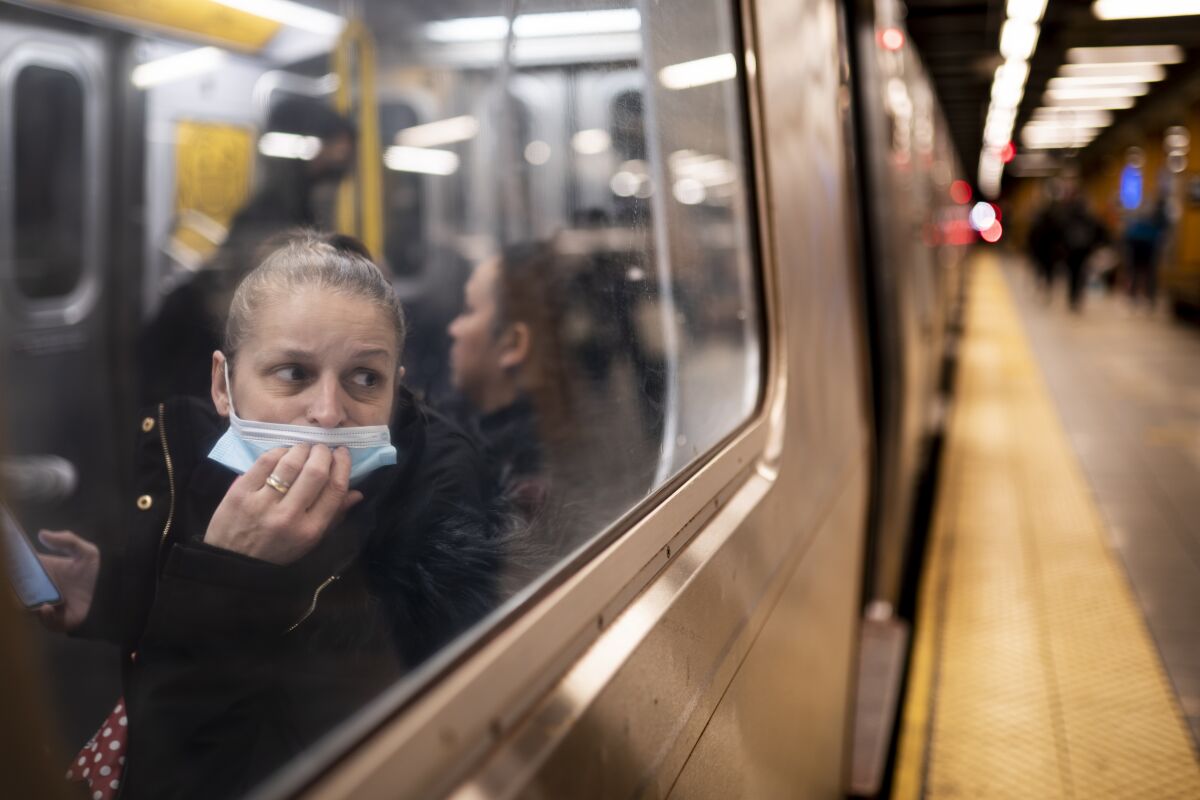 A passenger looks out onto the platform while riding a northbound train in 36th Street subway station where a shooting attack occurred the previous day during the morning commute, Wednesday, April 13, 2022, in New York. Mayor Eric Adams said Wednesday that officials were now seeking 62-year-old Frank R. James as a suspect. (AP Photo/John Minchillo)