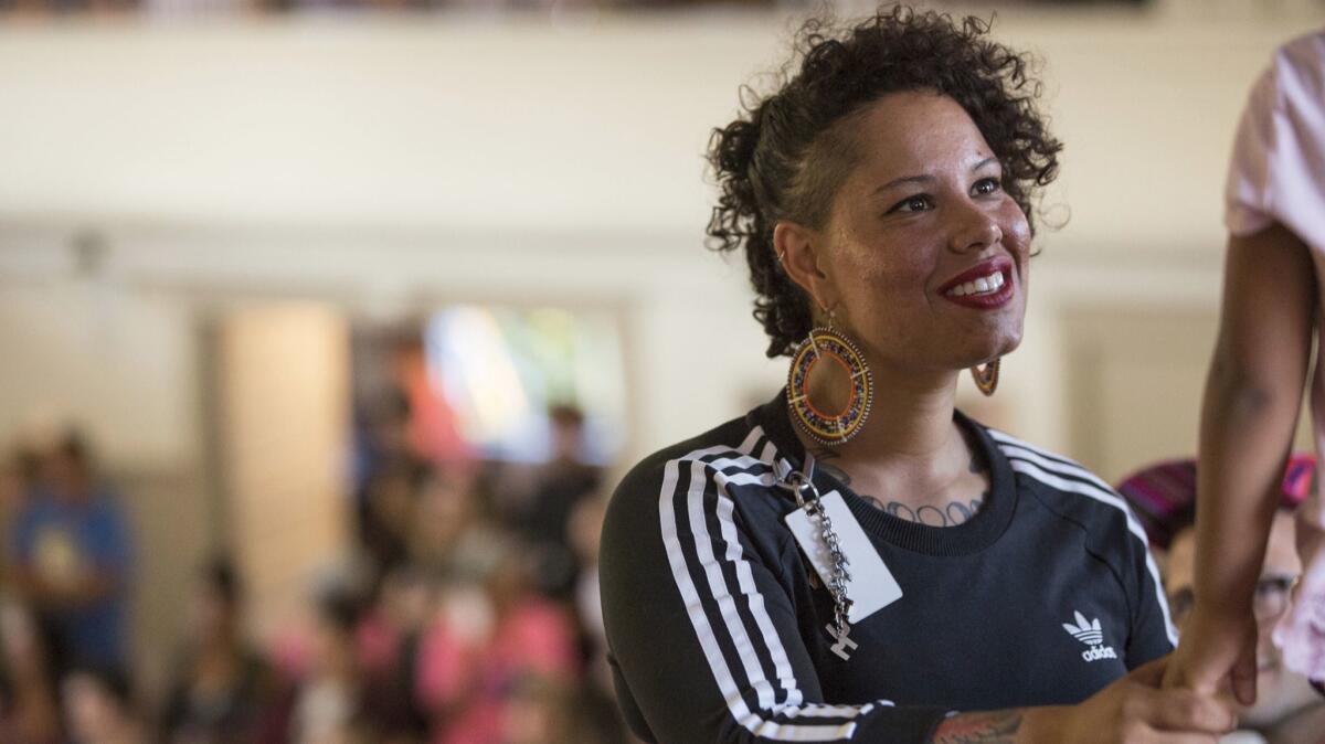 Nikkita Oliver greets a supporter in Seattle.