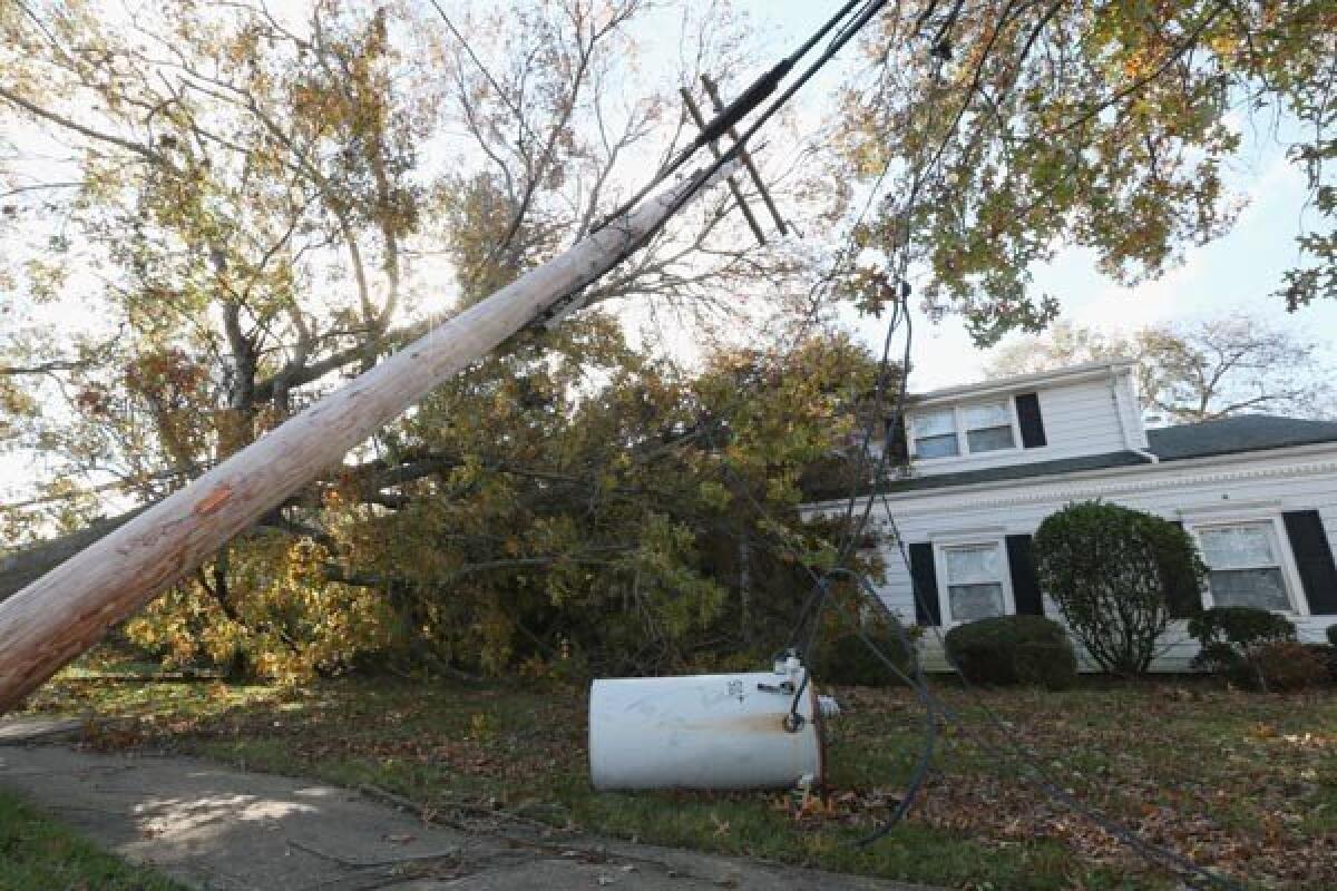 An electrical transformer and power lines rest in the yard of a house in the aftermath of Hurricane Sandy in Massapequa Park, N.Y.