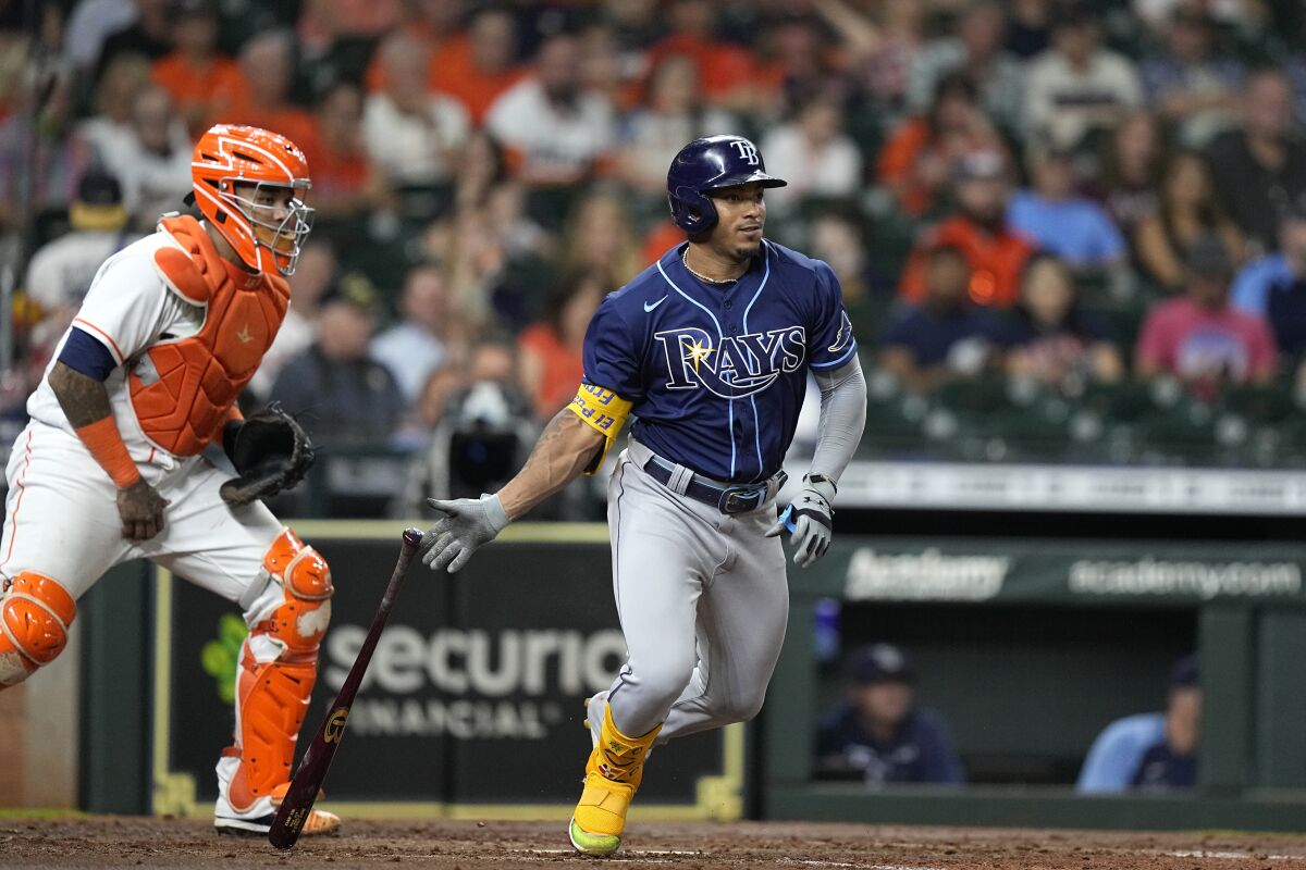 Tampa Bay Rays' Wander Franco, right, hits into a force out as Houston Astros catcher Martin Maldonado watches during the fourth inning of a baseball game Thursday, Sept. 30, 2021, in Houston. (AP Photo/David J. Phillip)