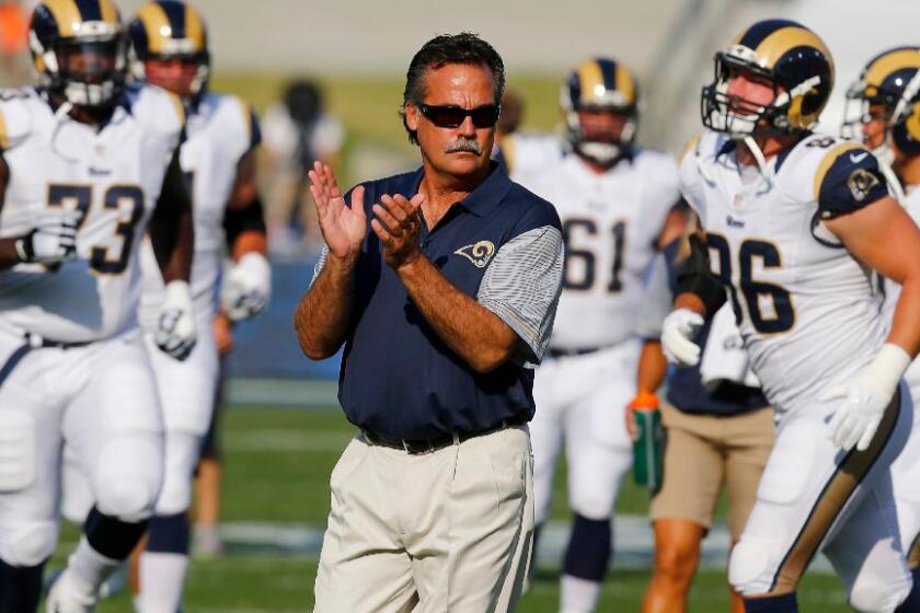 Rams Coach Jeff Fisher watches his team warm up before a preseason game against the Kansas City Chiefs at the Coliseum on Aug. 20.
