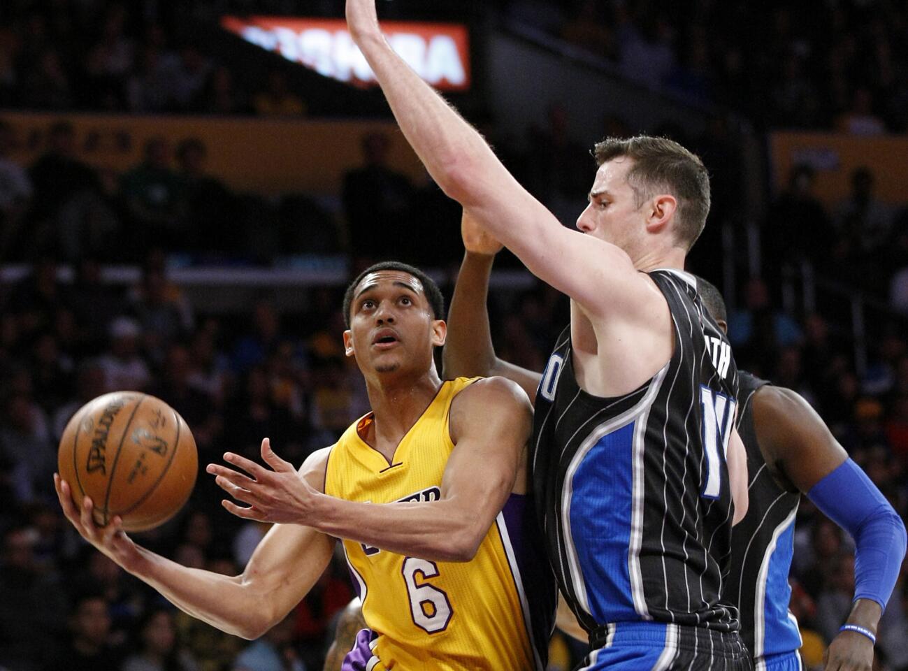 Lakers guard Jordan Clarkson drives around Magic center Jason Smith for a first-quarter basket on March 8 at Staples Center.