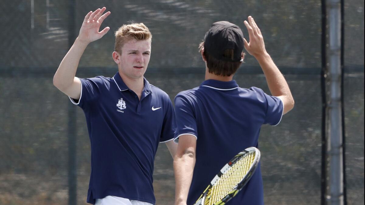 The Newport Harbor High boys' tennis doubles team of Josh Watkins, left, and Andy Myers react after defeating Brentwood in a CIF Southern Section Individuals tournament round of 32 match in South El Monte on Thursday, May 31.