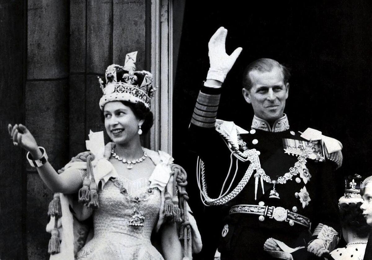 Britain's Queen Elizabeth II and Prince Philip, Duke of Edinburgh, are seen on the balcony at Buckingham Palace