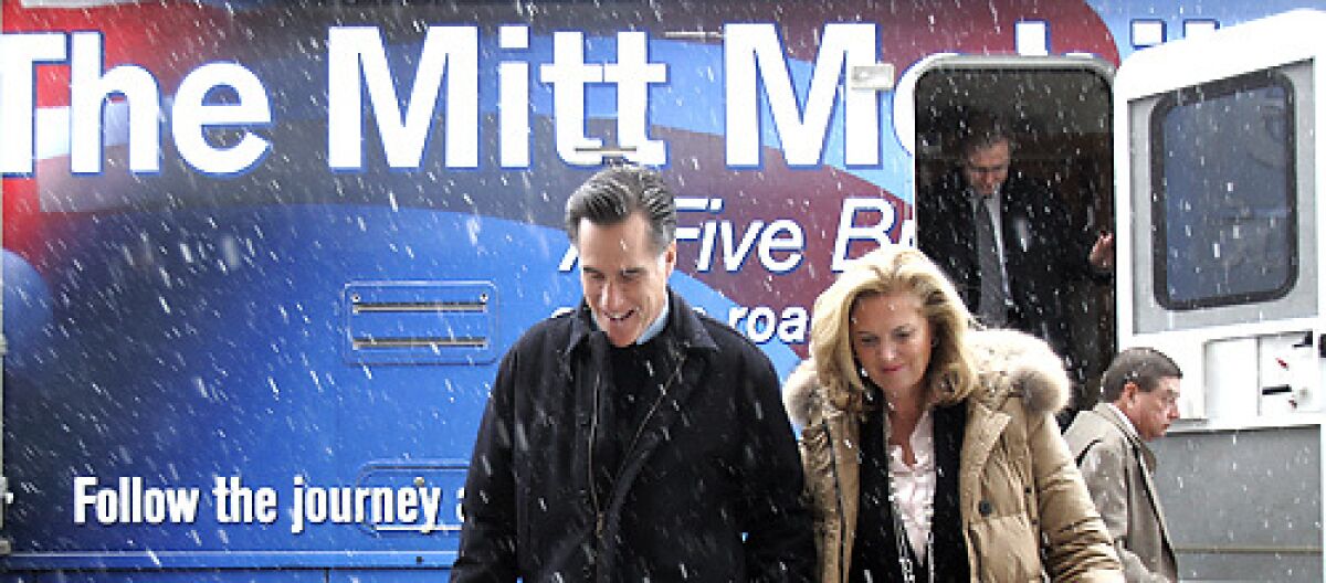 ITS COMING DOWN: Mitt Romney in Rock Rapids, Iowa, with wife Ann. His ads say John McCain voted against the Bush tax cuts twice and Mike Huckabee is soft on government spending.