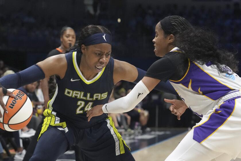 Dallas Wings guard Arike Ogunbowale (24) dribbles against Los Angeles Sparks guard Jordin Canada during the first half of a WNBA basketball basketball game in Arlington, Texas, Wednesday, June 14, 2023. (AP Photo/LM Otero)