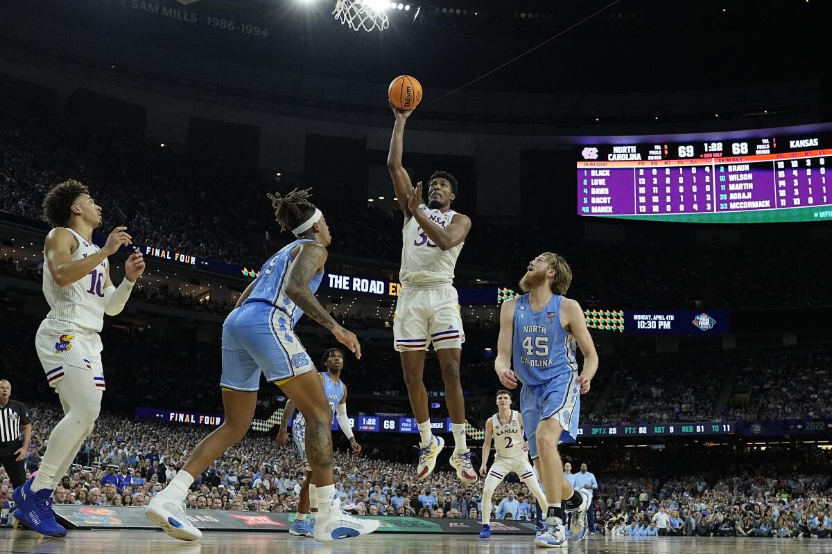 A basketball player takes a jump shot