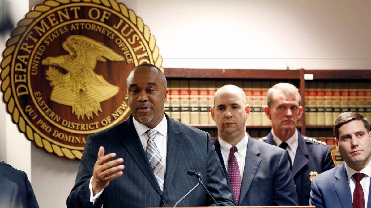 U.S. Atty. Robert Capers, left, speaks during a March 2 news conference in Central Islip, N.Y.