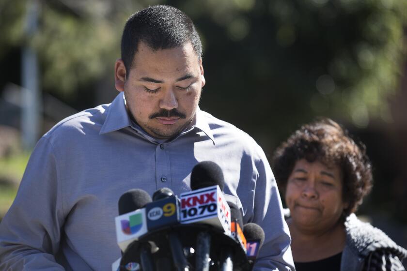 Daniel Sanchez reads a statement from his father, Jose Sanchez-Ramirez, outside the Ventura Hall of Justice, with his mother, Lucila Sanchez.