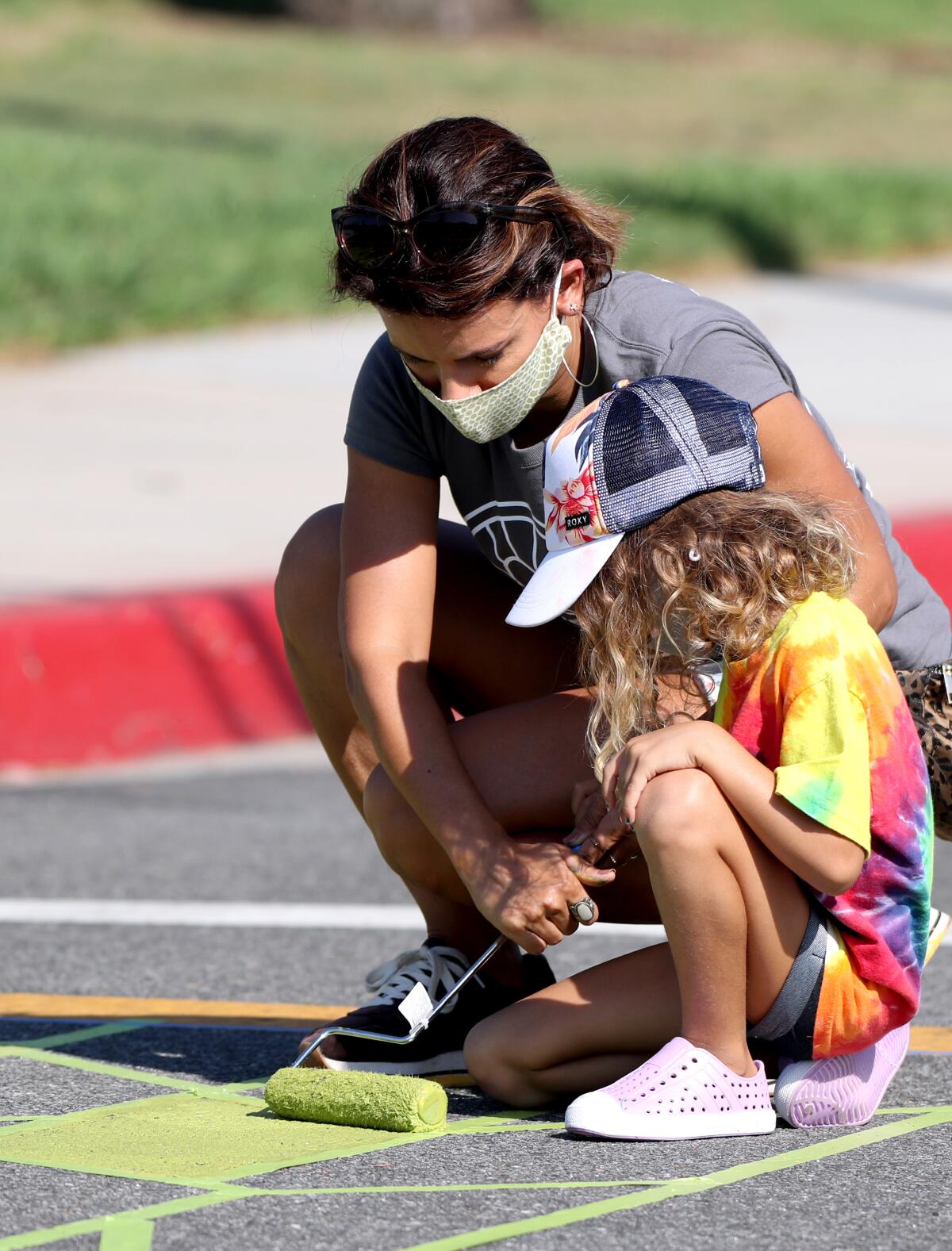  Aline Toler and daughter Summer, 5, of Costa Mesa, paint a crosswalk as part of Love Costa Mesa 2020. 