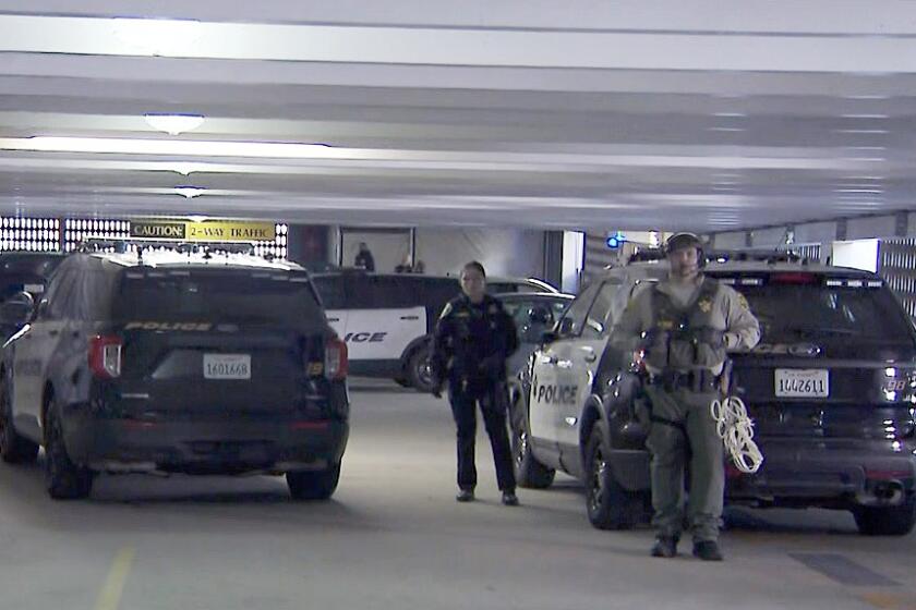 Police secure a parking structure at UCLA, where about 30 people were detained early Monday.