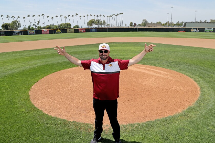 Estancia High baseball assistant coach Ty Harper poses for a portrait in front of the pitching mound at Estancia.