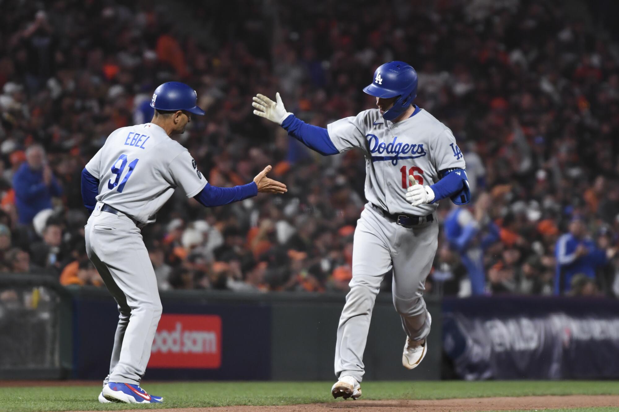 Los Angeles Dodgers' Will Smith celebrates with third base coach Dino Ebel after a solo home run