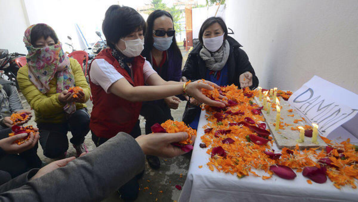 Foreign tourists offer flowers in Bodhgaya, India, last year in remembrance of an Indian woman who died after being gang-raped in a moving bus in December.