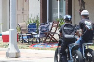 Beach chairs and a cooler rest at the corner of 16th St. and Pecan where the HBPD is investigating a stabbing attack that killed two people and injured three others that occurred at a multifamily residential complex at the corner in Huntington Beach.