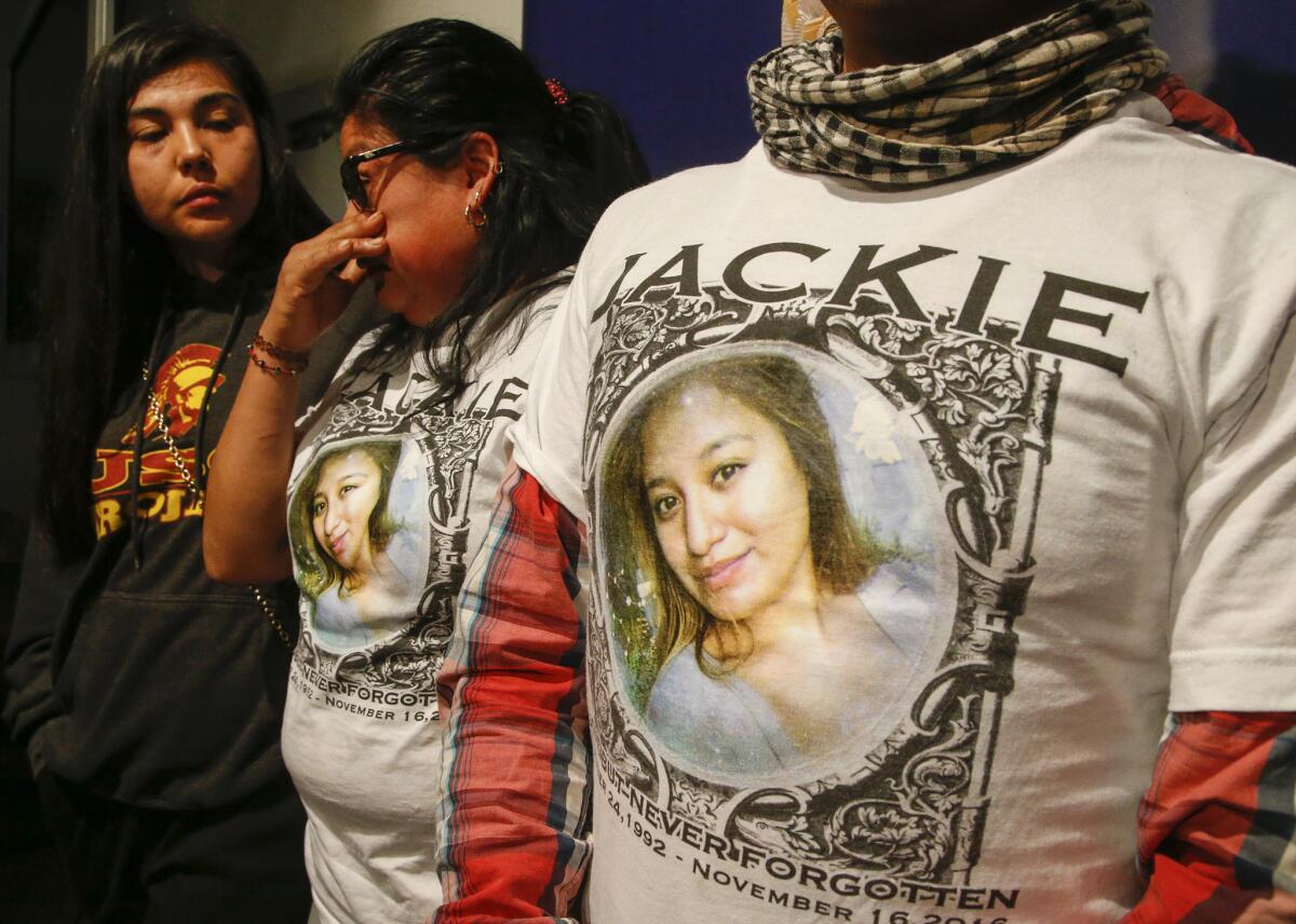 Jacqueline Hernandez's mother, Sandra Hernandez, center, and her father, Ruben Vicente, wear T-shirts with their daughter's photo on them during a news conference with family friend Rhina Calderon at LAPD headquarters.