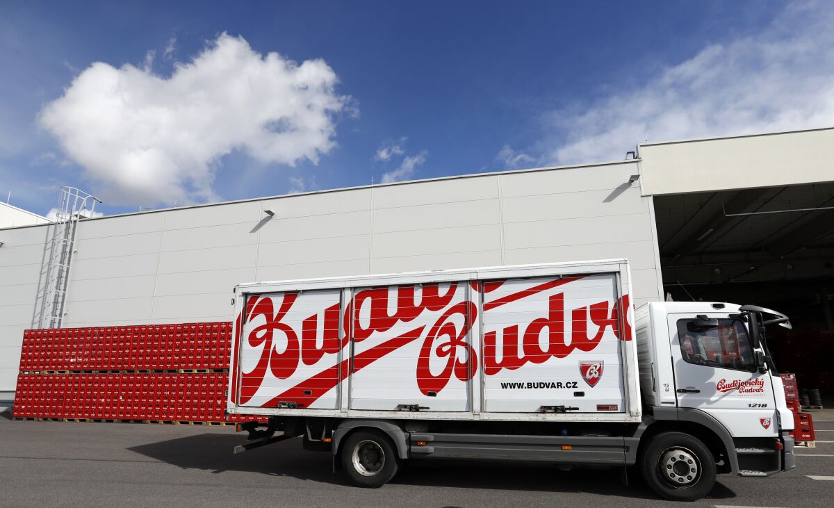 FILE - A truck drives past cases of beer at the Budejovicky Budvar brewery in Ceske Budejovice, Czech Republic, on March 11, 2019. Budvar, the Czech brewer that has been in a long legal dispute with U.S. company Anheuser-Busch over use of the “Budweiser” brand, has increased its beer exports last year despite the pandemic. Budejovicky Budvar NP, a 126-year-old state-owned brewery, said on Monday its exports were up a record of 11% in 2021, reaching 1.3 million hectoliters (34.3 million gallons). (AP Photo/Petr David Josek, File)