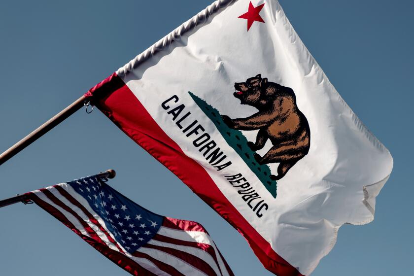 California's state flag flies next to the U.S. flag