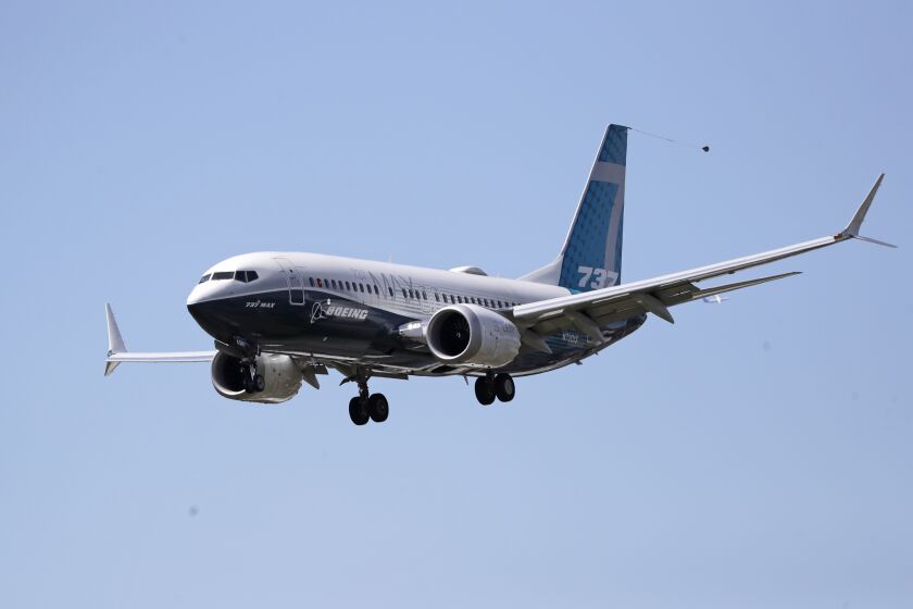 A Boeing 737 MAX jet heads to a landing at Boeing Field following a test flight Monday, June 29, 2020, in Seattle. The jet took off from Boeing Field earlier in the day, the start of three days of re-certification test flights that mark a step toward returning the aircraft to passenger service. The Federal Aviation Administration test flights over the next three days will evaluate Boeing's proposed changes to the automated flight control system on the MAX, a system that activated erroneously on two flights that crashed, killing 346 people. (AP Photo/Elaine Thompson)