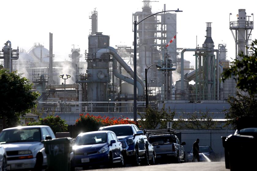 LOS ANGELES, CALIF. - OCT. 4, 2022. A residential street abuts the Conoco Phillips refinery in Wilmington. (Luis Sinco / Los Angeles Times)