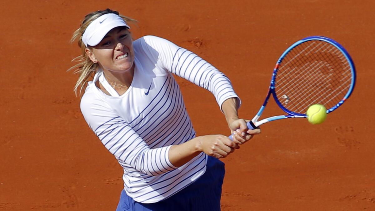 Maria Sharapova hits a return during her first-round win over Kaia Kanepi at the French Open on Monday.