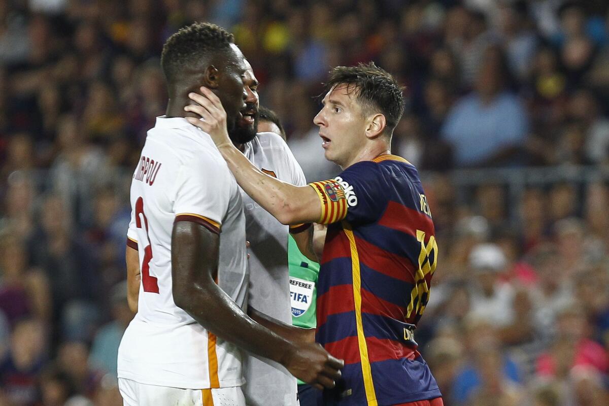 Barcelona forward Lionel Messi grabs AS Roma defender Mapou Yanga-Mbiwa by the throat during a friendly match Wednesday at Camp Nou stadium.