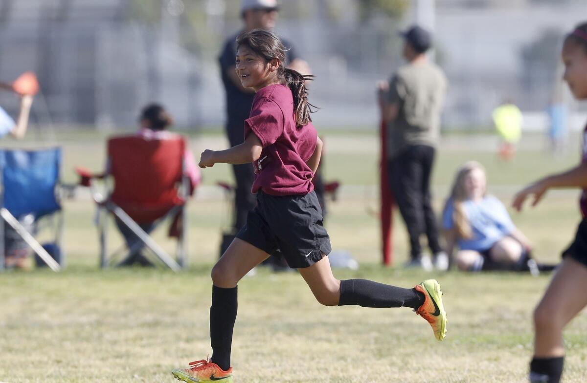 Sonora Elementary's Vanessa Zarate is all smiles after scoring a goal against California in a girls’ third- and fourth-grade Bronze Division pool-play match at the Daily Pilot Cup on Thursday at Costa Mesa High.